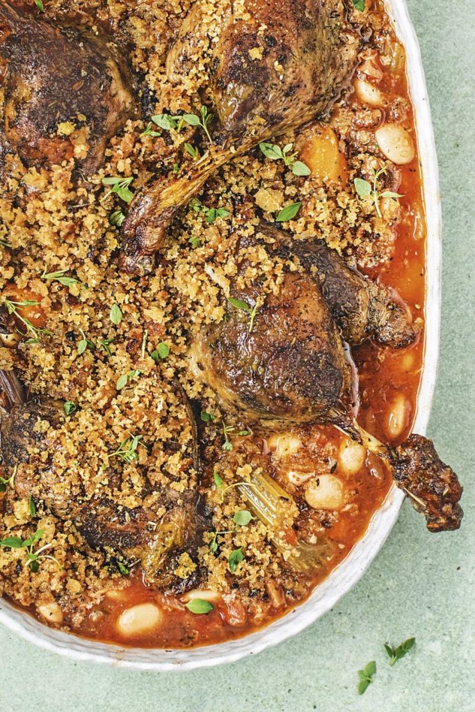 Overhead shot of duck legs cassoulet made in a slow cooker.