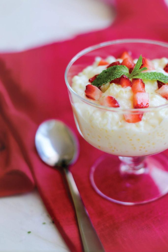 Rice pudding with coconut milk and strawberries in a glass.