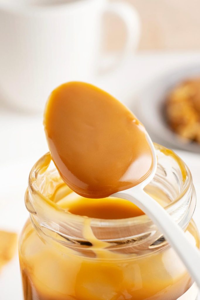 Spoonful of caramel made from slow-cooked sweetened condensed milk.