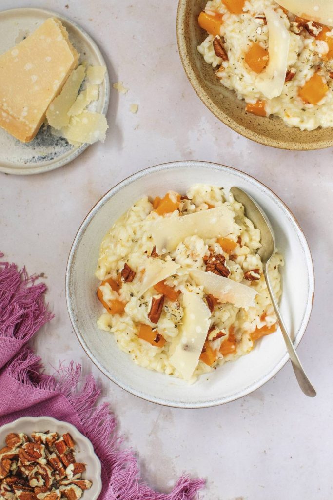 A creamy bowl of slow cooker butternut squash risotto with cheese.