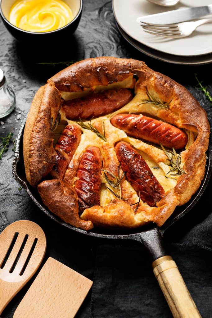 Toad in the hole in a cast-iron skillet, straight from the slow cooker.