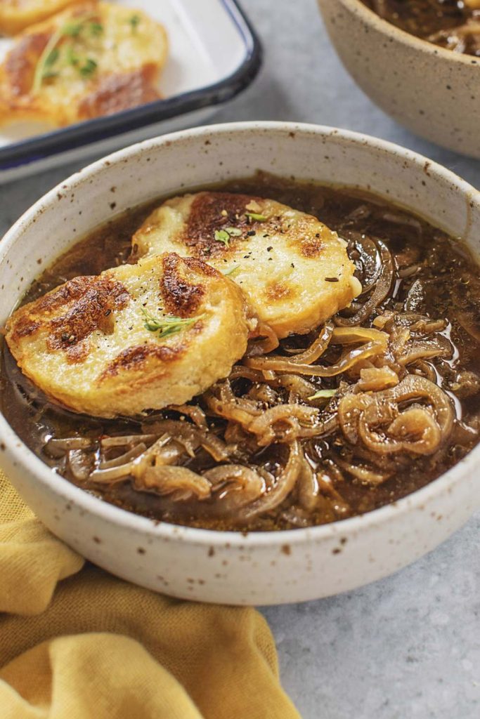 Close-up of Slow Cooker French Onion Soup with melted cheese toast.
