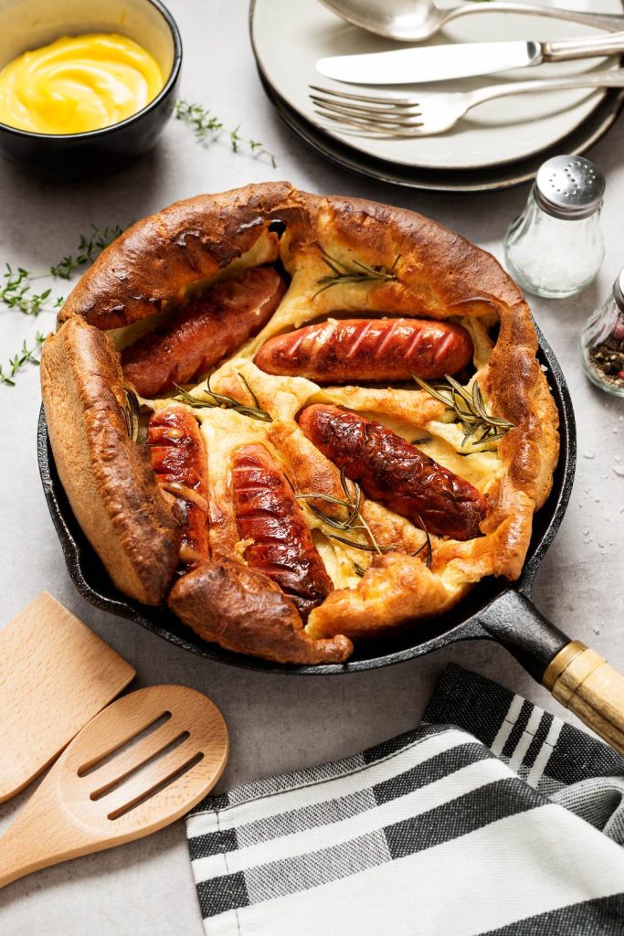 Golden toad in the hole served in a skillet, ready to eat.