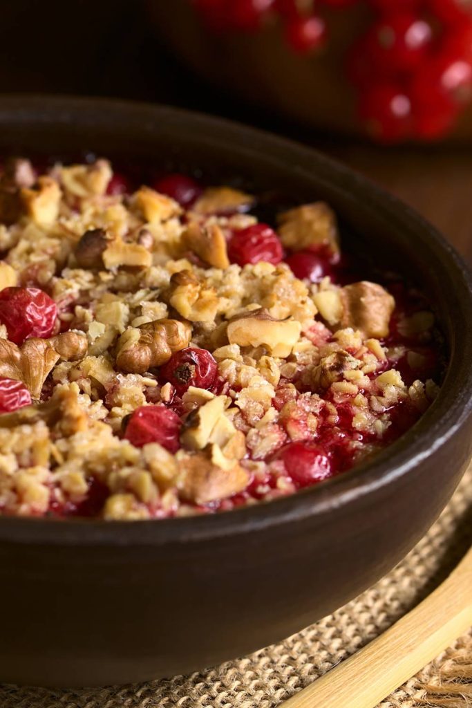 Pot of berry crumble with nuts made in a slow cooker.