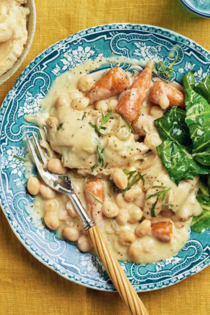 Slow Cooker Tarragon Chicken with chickpeas and greens on a decorative plate.