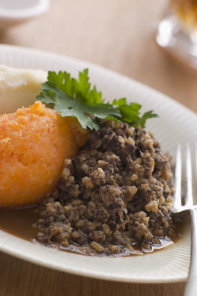 Slow Cooker Haggis with mashed turnips and potatoes on a plate.