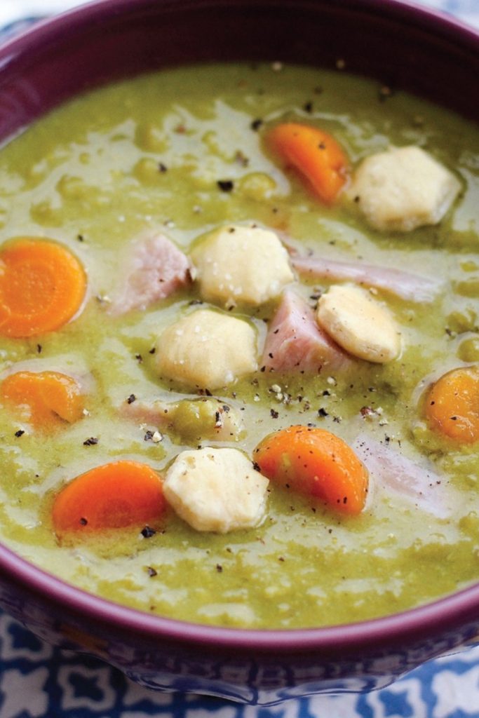 creamy split pea soup with ham pieces and carrot slices.