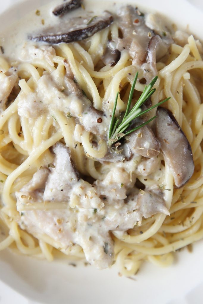 Slow Cooker Chicken Boscaiola with mushrooms and rosemary on spaghetti.