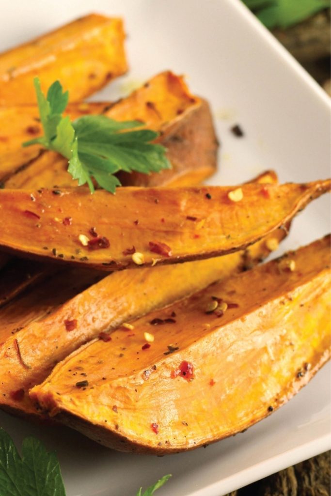 Slow Cooker Sweet Potato Wedges with seasoning and parsley.
