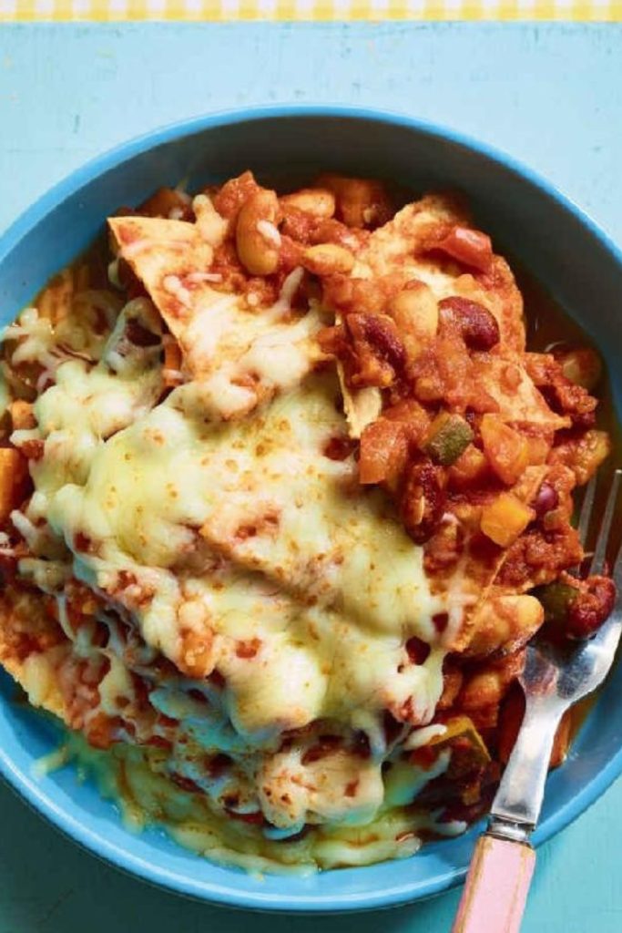 Slow Cooker Vegetarian Enchiladas with melted cheese in a blue bowl.