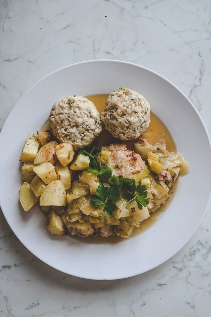 Slow Cooker Chicken and Leek Casserole served with dumplings and potatoes.