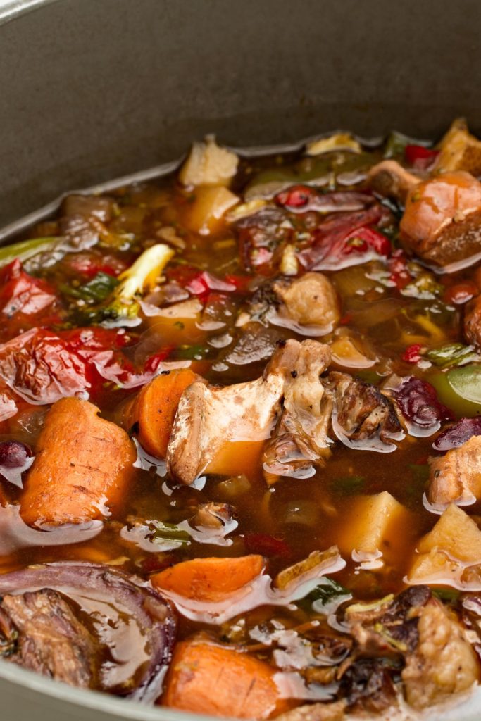 Slow Cooker Kangaroo Tail Soup with vegetables simmering in a pot.