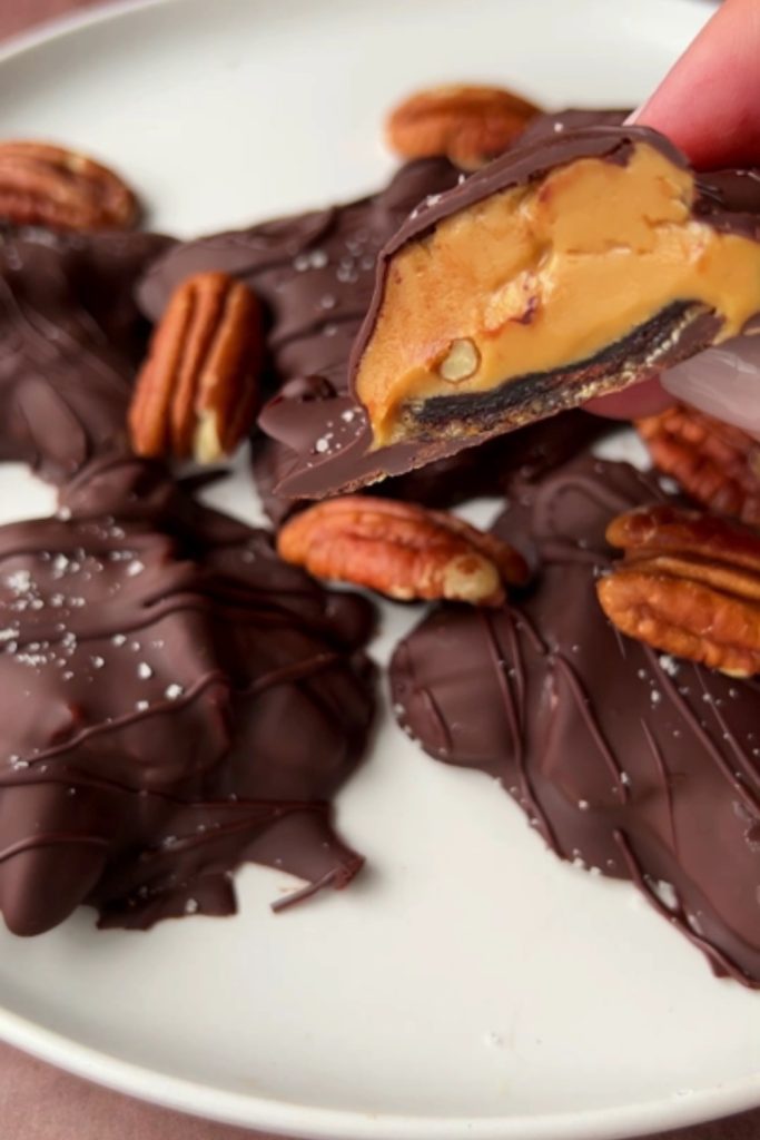 Slow Cooker Chocolate Turtle cut in half, showing caramel and pecan filling.