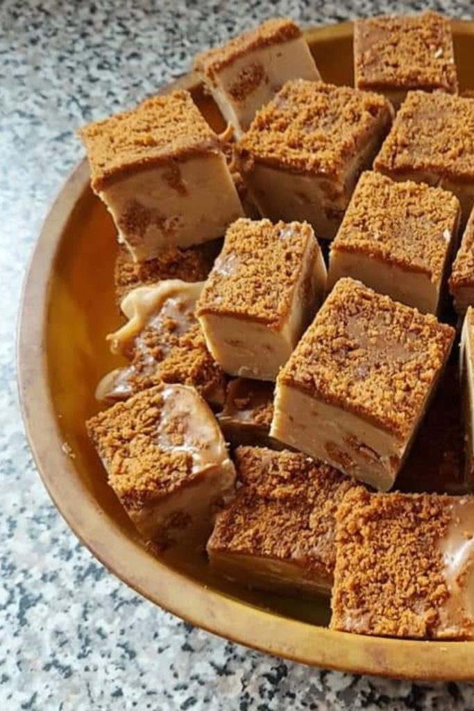 Slow Cooker Lotus Biscoff Fudge squares on a brown plate.