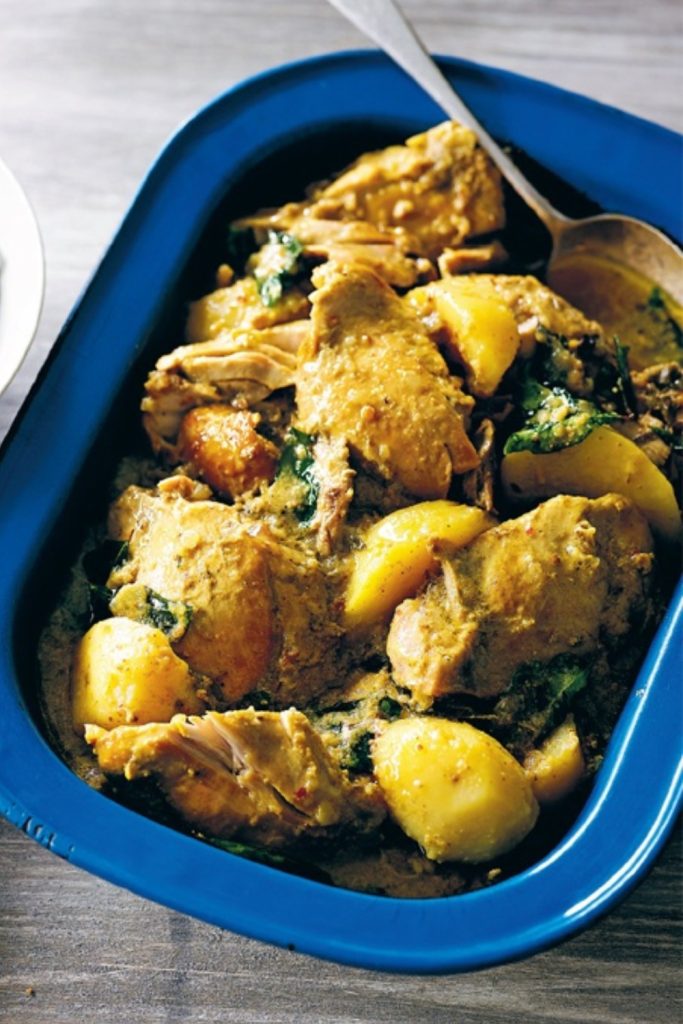 Slow Cooker Malaysian Chicken Curry served in a blue dish with tender chicken and potatoes.