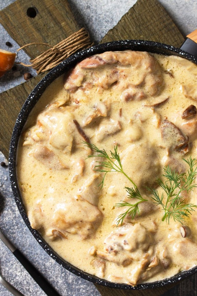 Slow Cooker Chicken and Camembert in a creamy sauce with fresh dill garnish.