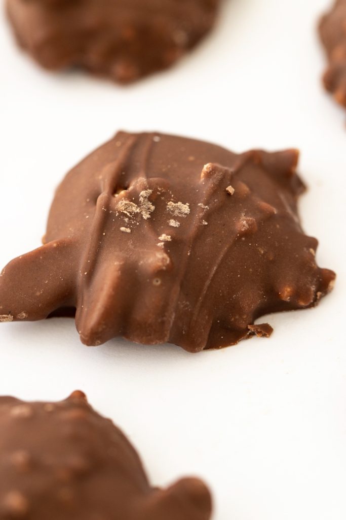slow cooker chocolate turtle candy with a sprinkle of sea salt.