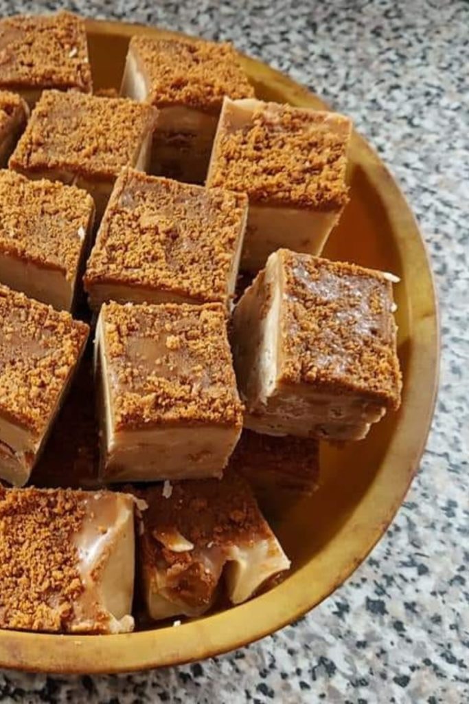 Lotus Biscoff Fudge squares in a brown plate made in a slow cooker.