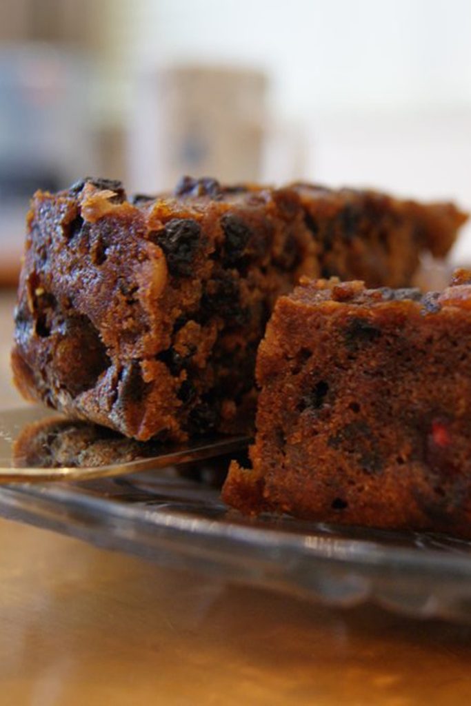  a slice of 4-ingredient Slow Cooker Fruit Cake with visible dried fruits.