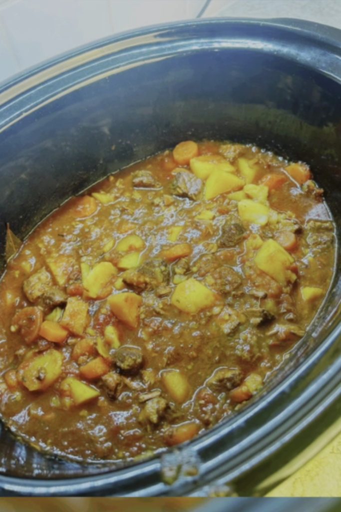 Beef and Ale Slow Cooker Casserole with potatoes and carrots in a slow cooker.