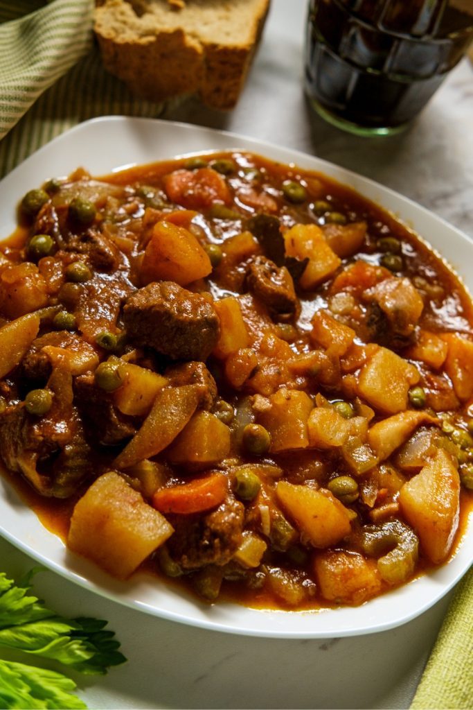 Jumbuck Stew in a white plate, showcasing tender meat and vegetables in a rich sauce.