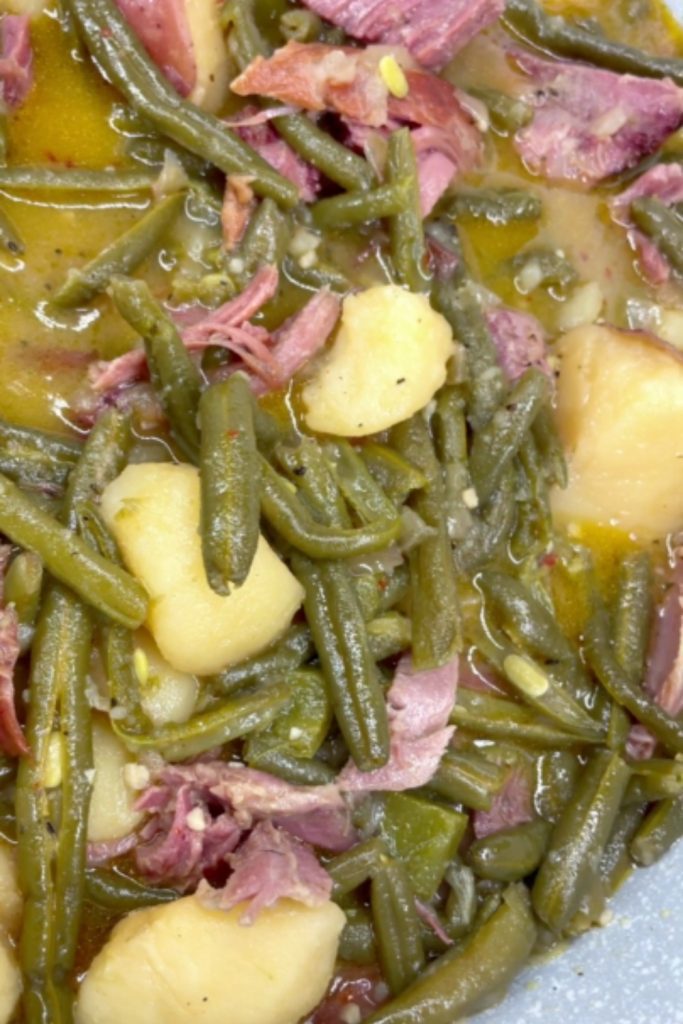 Slow Cooker Green Beans with Smoked Turkey, featuring a rich broth and tender vegetables.