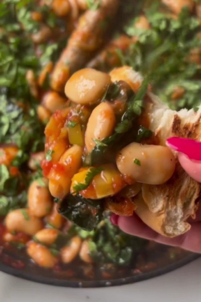 Slow Cooker Sausage and Butter Bean Casserole served on bread.