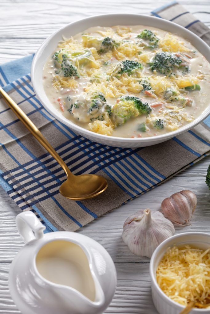 Pot of 4-ingredient Slow Cooker Broccoli Cheese Soup with a ladle scooping soup.