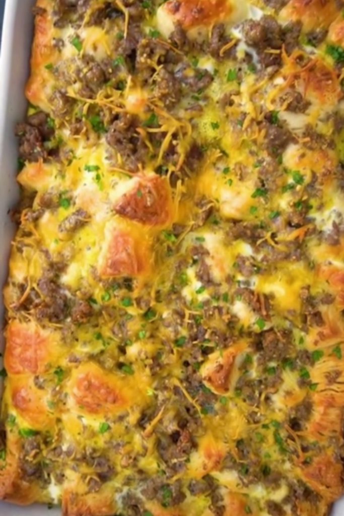 Slow Cooker Biscuit Breakfast Casserole with melted cheese and sausage.