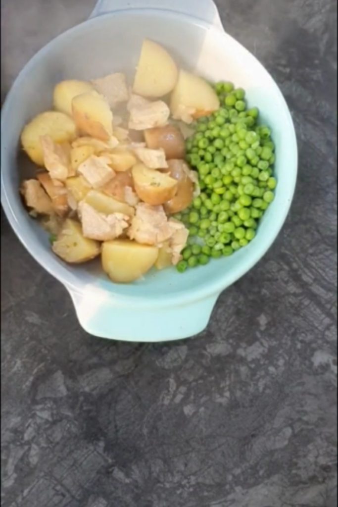 Pork and Cider Casserole with potatoes and peas in a bowl.