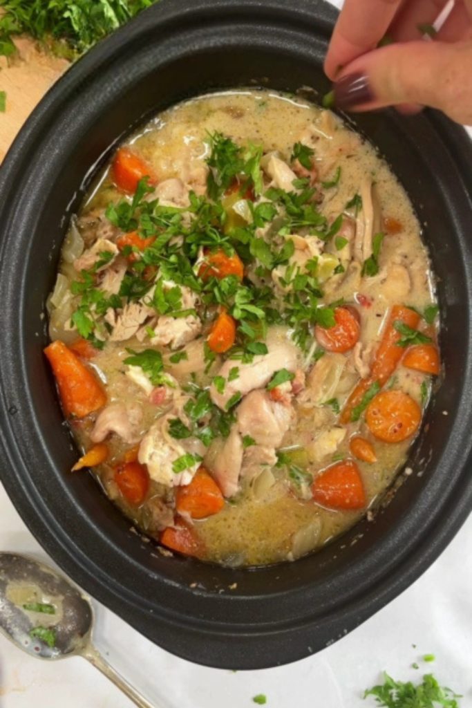 Slow Cooker Chicken and Bacon Casserole topped with parsley, ready to serve.