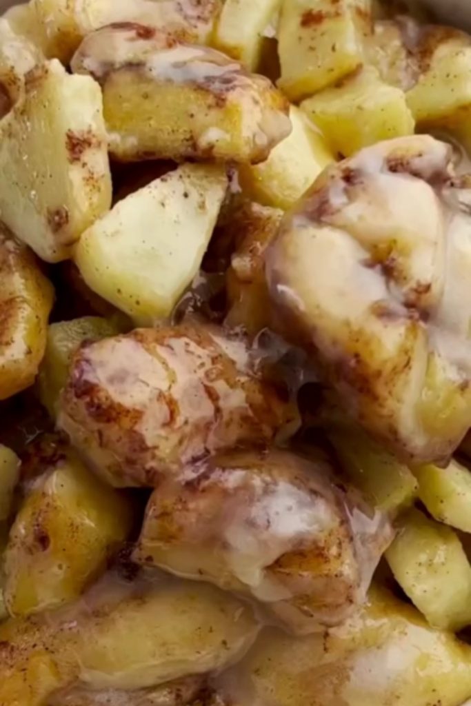 Slow Cooker Cinnamon Roll Casserole with Apples, showing the texture and glaze.