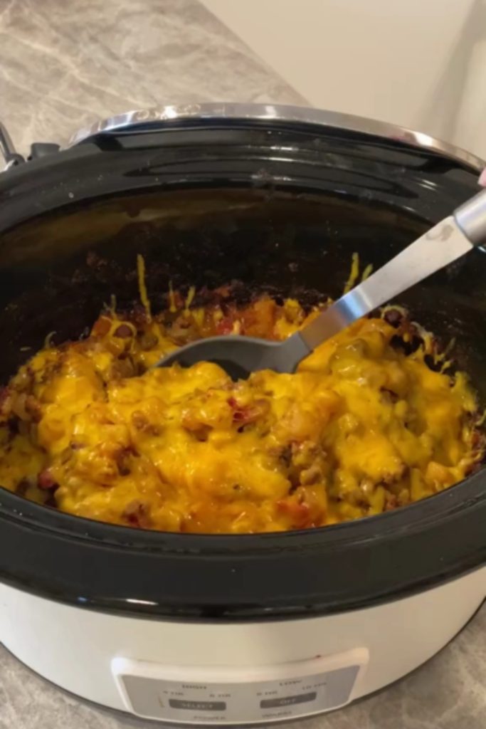 Slow Cooker Taco Casserole with melted cheese in a slow cooker.