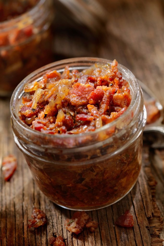 Slow Cooker Bacon Jam in a jar, showing the crispy texture.