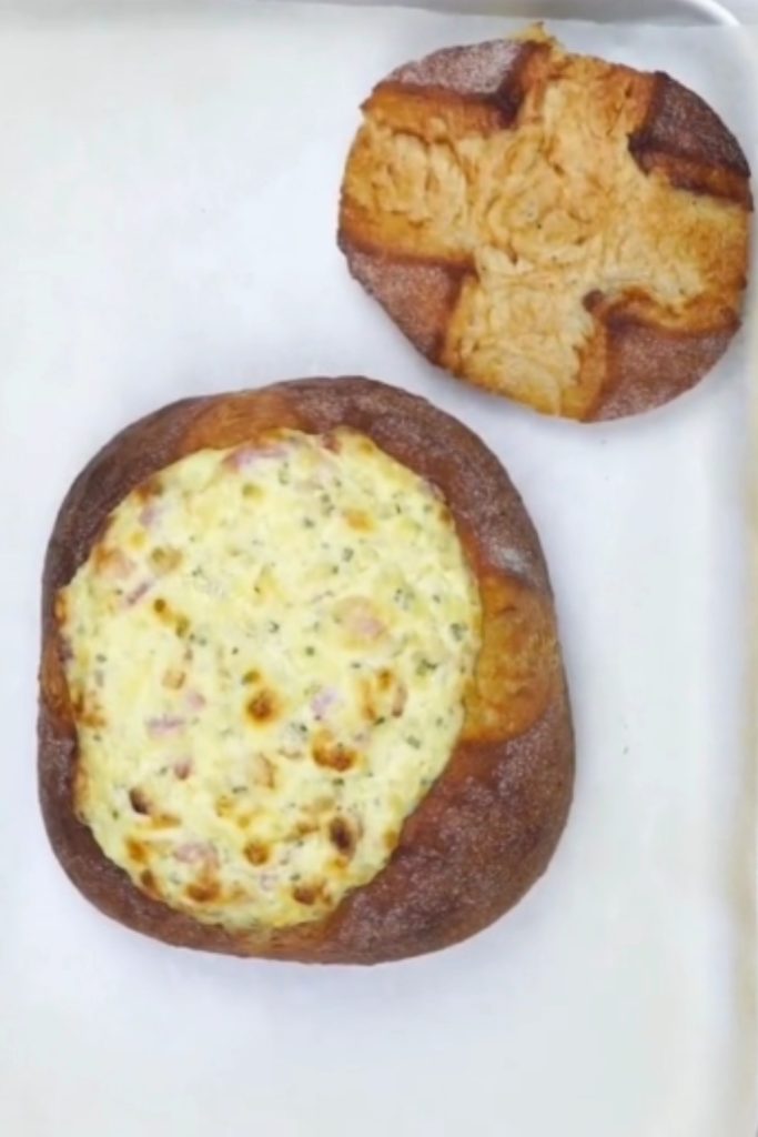 Slow Cooker Bacon Corn Cob Loaf with the top removed, filled with creamy bacon and corn mixture.