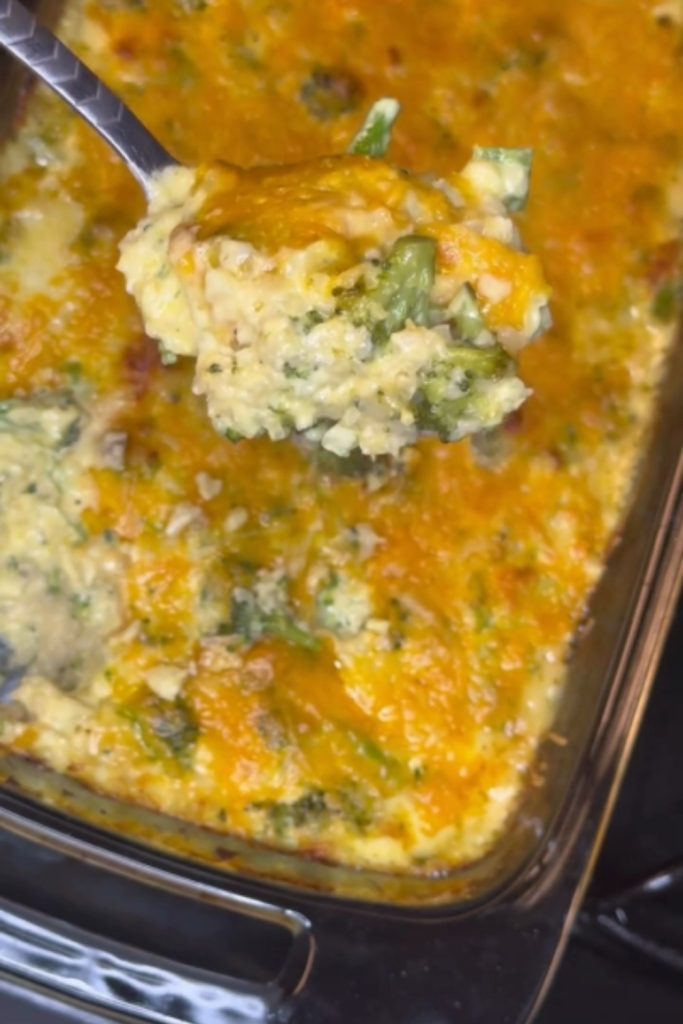 Slow Cooker Broccoli Rice and Cheese Casserole with a spoonful being served.