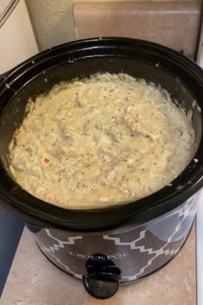 Crockpot filled with creamy garlic parmesan chicken.