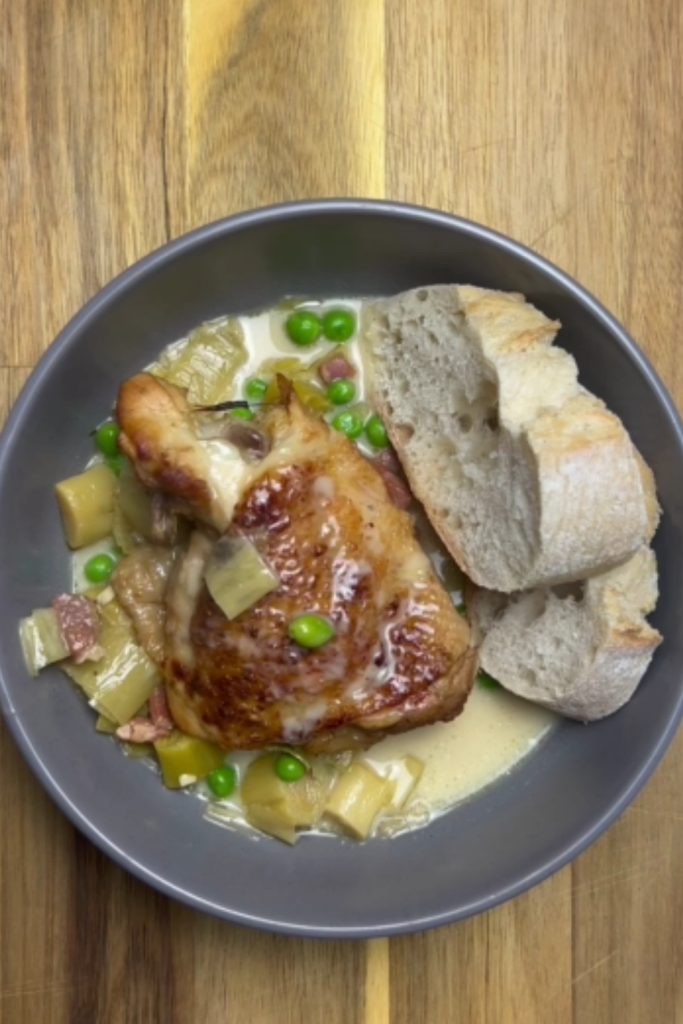 Slow Cooker Honey Mustard Chicken with peas and bread on the side.