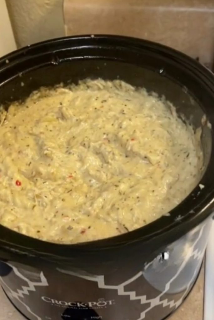 Garlic parmesan chicken cooking in a crockpot.