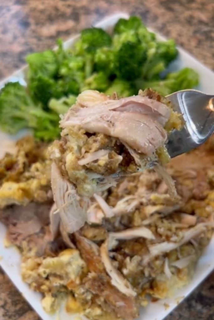 Plate of slow cooker chicken and stuffing served with broccoli.