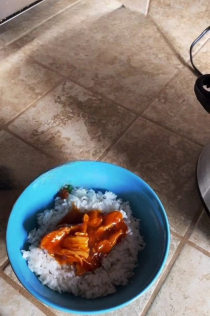 sriracha chicken with rice in a blue bowl.